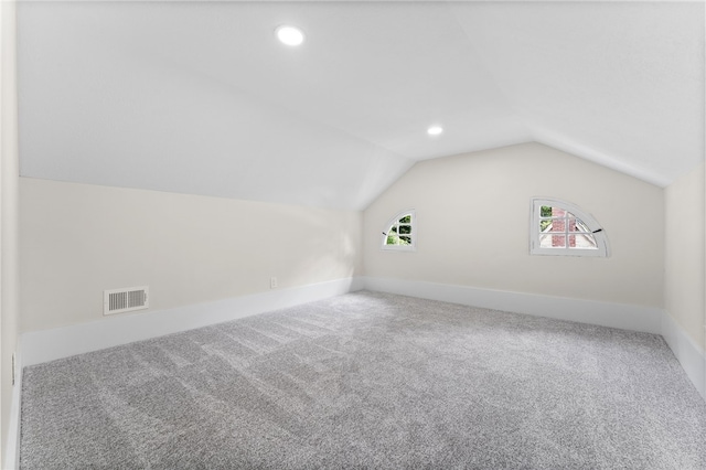 bonus room featuring carpet floors and lofted ceiling