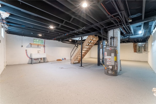 basement featuring gas water heater and sink