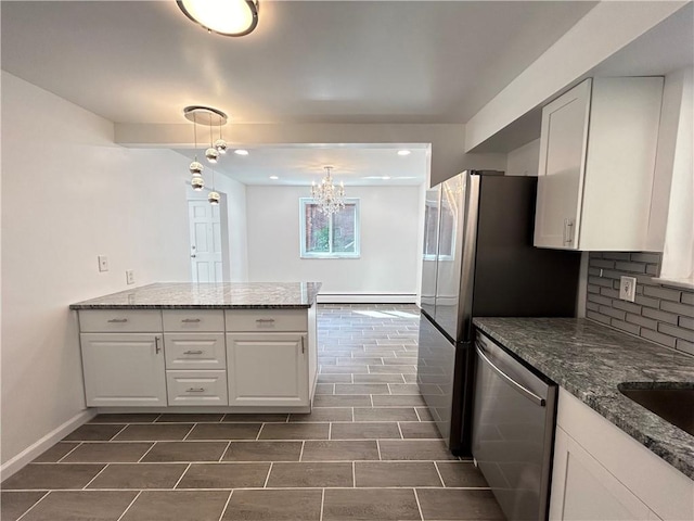 kitchen featuring stainless steel dishwasher, white cabinets, a baseboard radiator, and pendant lighting