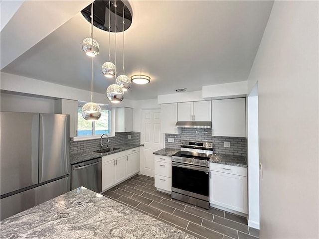 kitchen with appliances with stainless steel finishes, pendant lighting, white cabinets, and sink