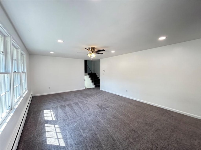 unfurnished room featuring ceiling fan, dark carpet, and a baseboard radiator