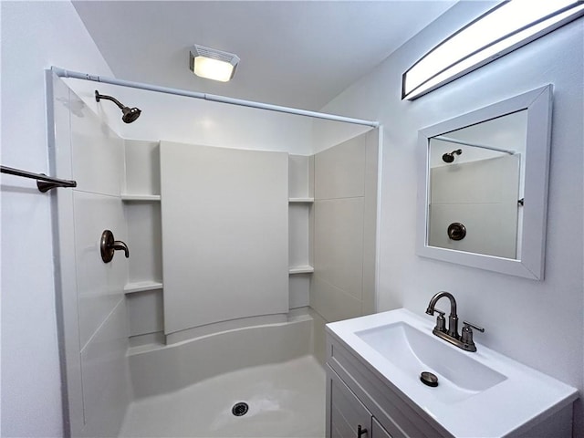 bathroom with a shower and vanity