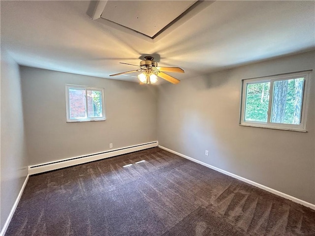 carpeted spare room featuring baseboard heating, a wealth of natural light, and ceiling fan