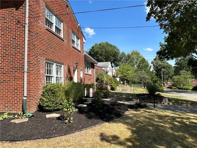 view of side of property with a yard