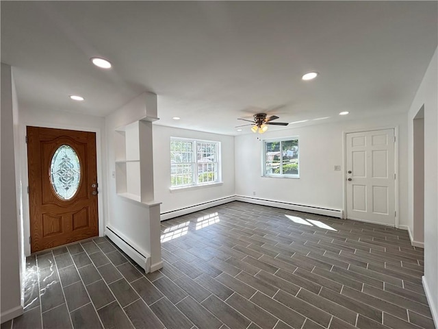 foyer with ceiling fan and a baseboard heating unit