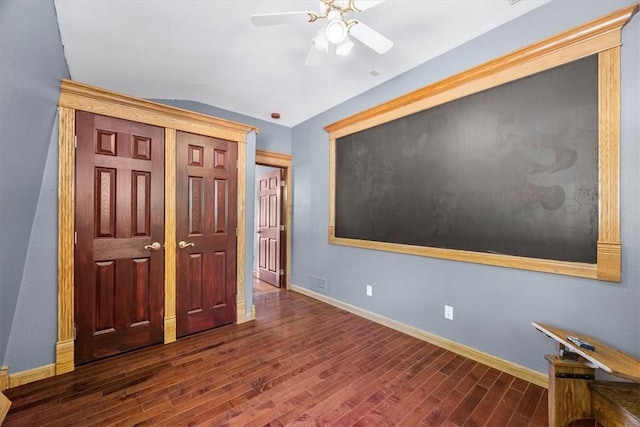 unfurnished bedroom featuring ceiling fan and dark hardwood / wood-style floors