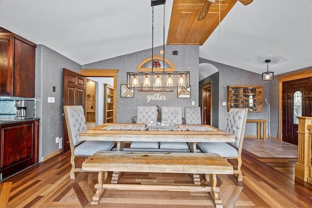 dining area with lofted ceiling and wood-type flooring