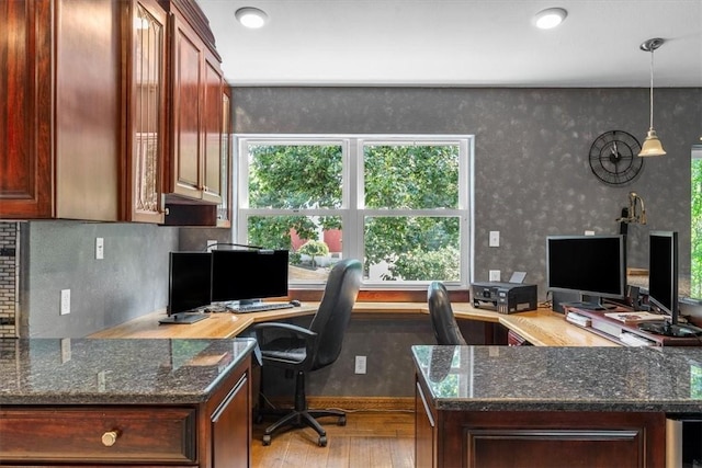 office area featuring light hardwood / wood-style flooring and built in desk