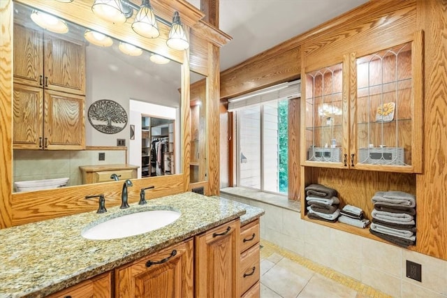 bathroom featuring toilet, vanity, and tile patterned floors