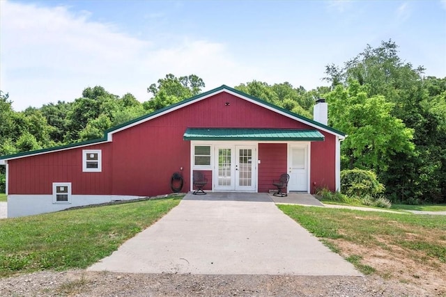 view of front of property featuring a front lawn and french doors