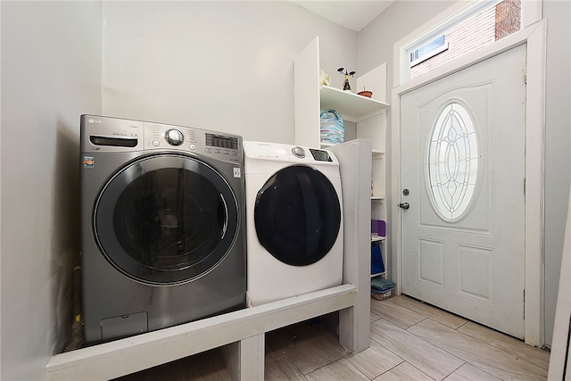 clothes washing area featuring washer and clothes dryer