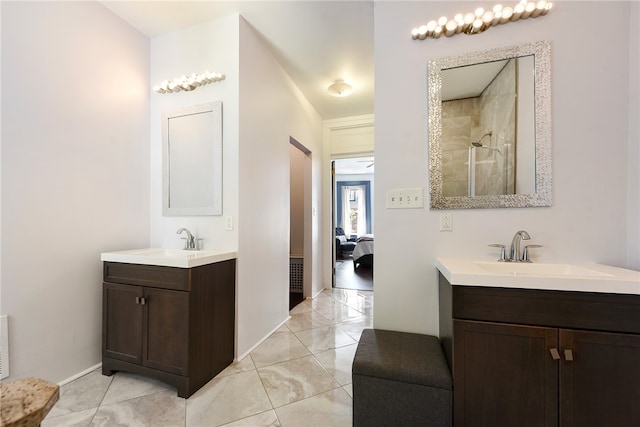 bathroom featuring a shower, tile patterned flooring, and dual bowl vanity