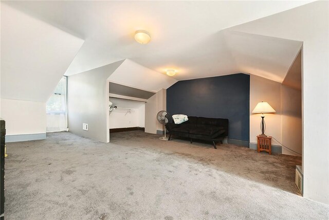 bonus room featuring vaulted ceiling and carpet floors