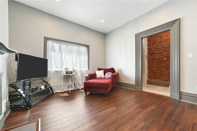 sitting room with wood-type flooring