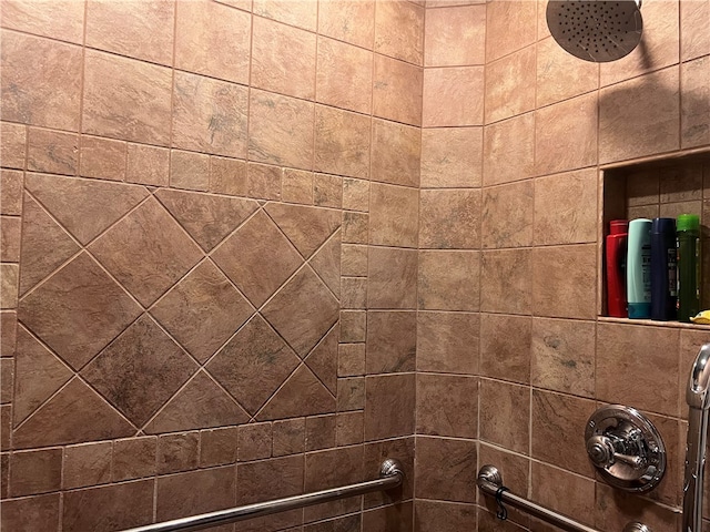 interior details featuring a tile shower