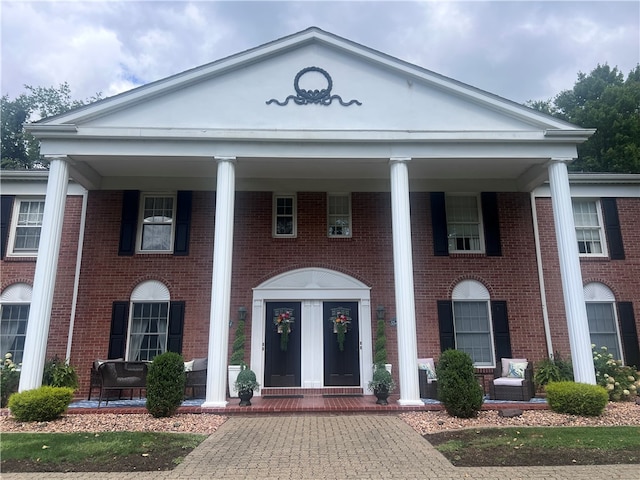 neoclassical / greek revival house featuring a porch