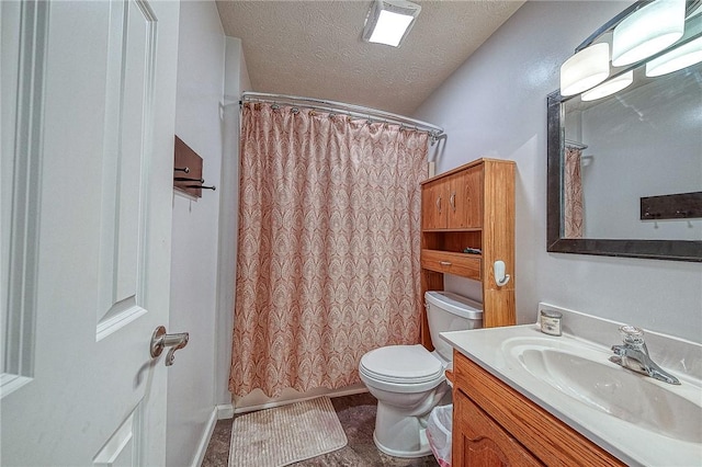 full bathroom featuring a textured ceiling, toilet, and vanity