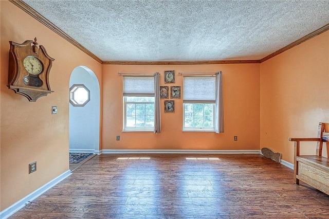 entryway with baseboards, arched walkways, dark wood-style flooring, and ornamental molding