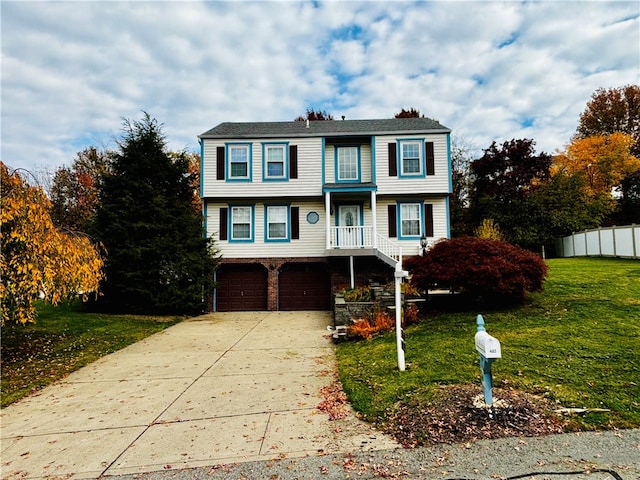 view of front of house with a front yard and a garage