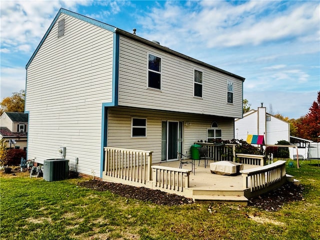 rear view of house featuring cooling unit, a yard, and a wooden deck