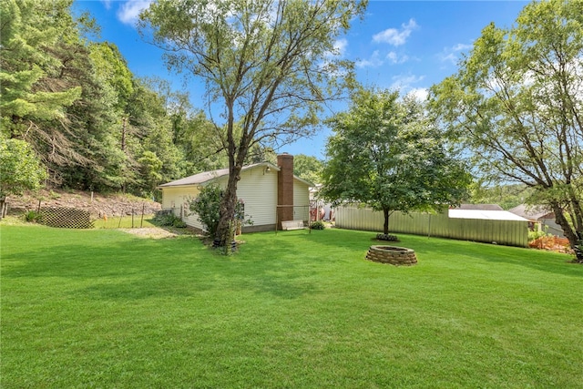 view of yard with a fire pit