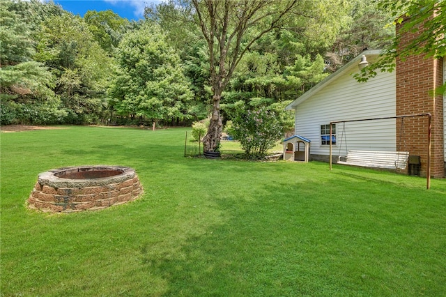 view of yard with a fire pit