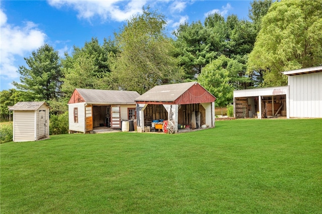 back of house with a lawn and an outbuilding