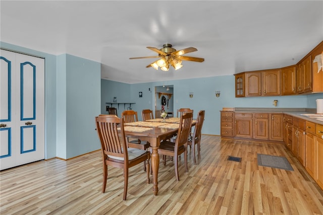 dining room featuring light hardwood / wood-style floors and ceiling fan