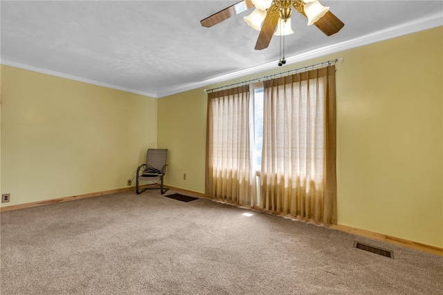 carpeted spare room with crown molding and ceiling fan