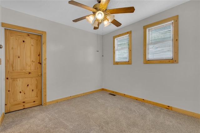 spare room featuring ceiling fan and carpet flooring