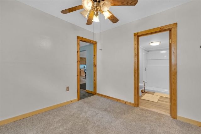 unfurnished bedroom with carpet floors, ensuite bath, and ceiling fan