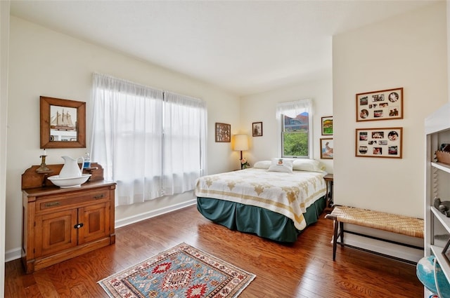 bedroom featuring baseboards and wood finished floors