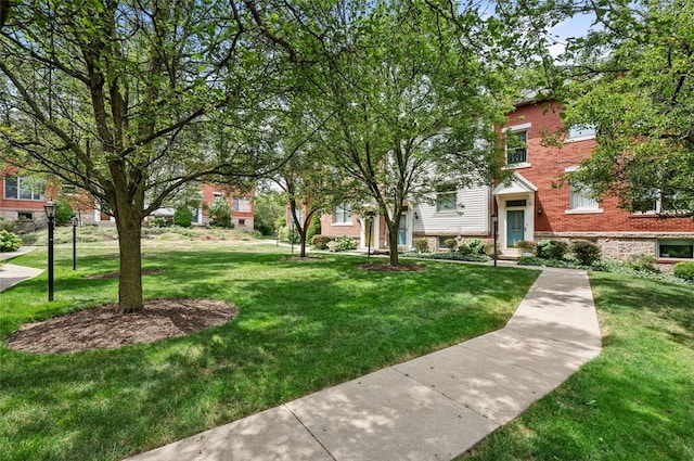 view of property's community featuring a yard