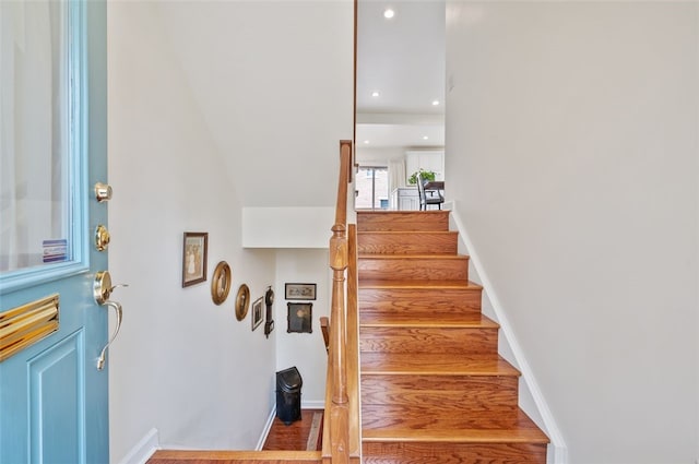 stairway with baseboards, wood finished floors, and recessed lighting