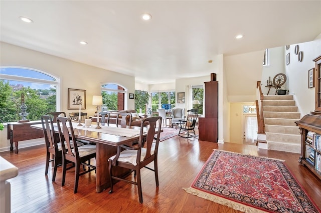 dining space with stairs, wood finished floors, and recessed lighting