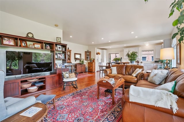 living room with light wood-type flooring and recessed lighting