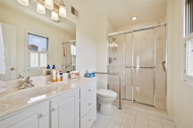 bathroom with toilet, vanity, visible vents, and a shower stall