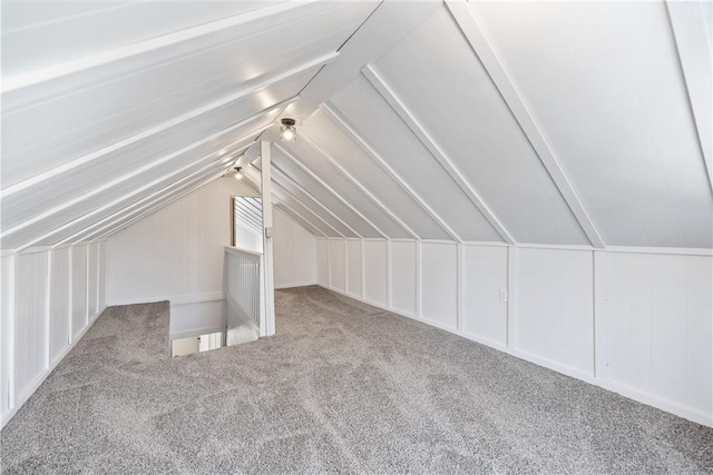 additional living space with carpet flooring and lofted ceiling