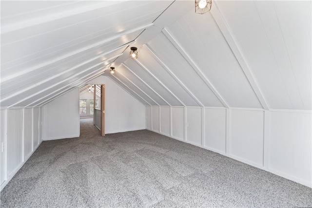 additional living space with carpet flooring and vaulted ceiling