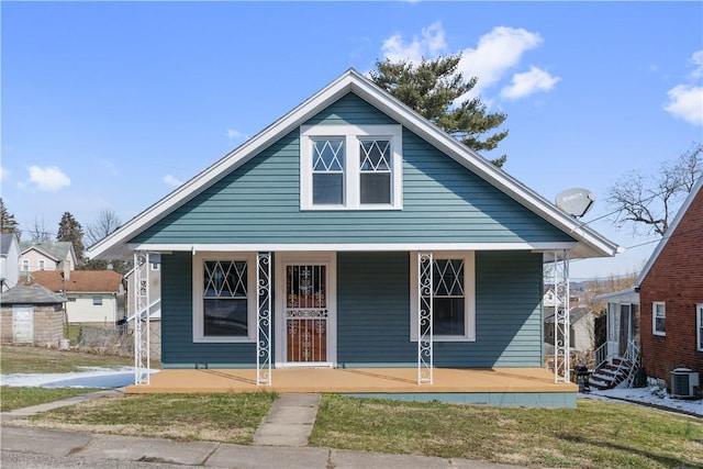 bungalow featuring a porch and central air condition unit