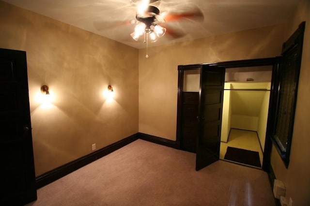 unfurnished bedroom featuring ceiling fan, light colored carpet, and a closet