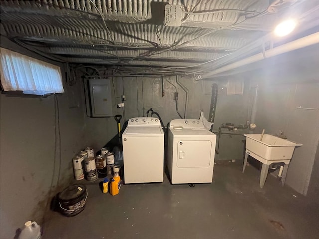 basement featuring electric panel, sink, and independent washer and dryer