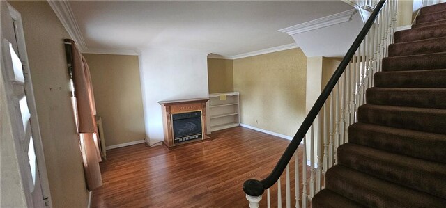 stairs with crown molding and hardwood / wood-style flooring