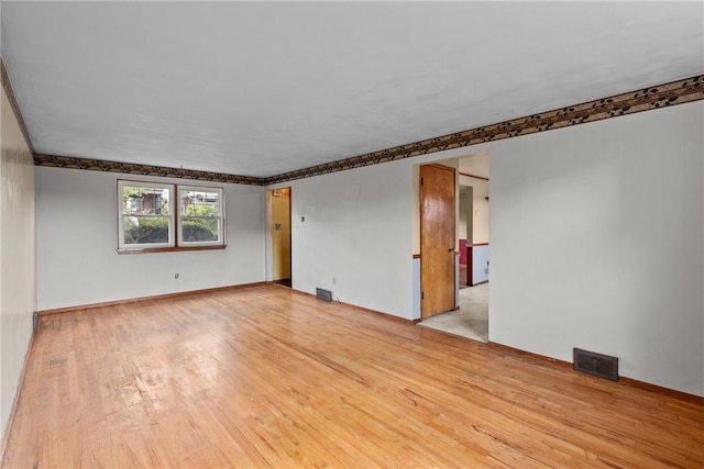 spare room featuring light wood-type flooring