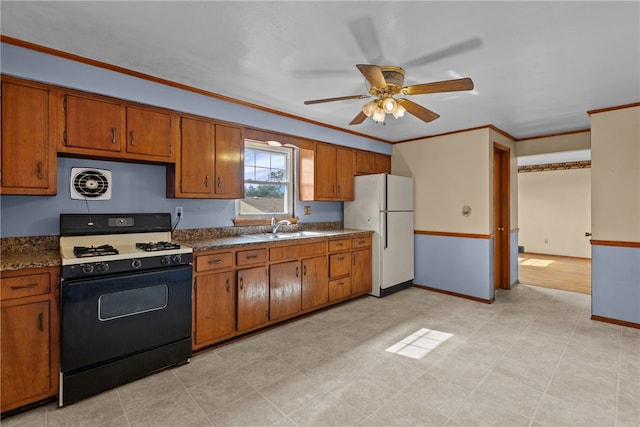 kitchen with white appliances, sink, light tile patterned floors, ceiling fan, and ornamental molding