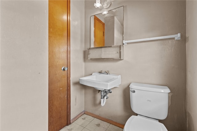 bathroom featuring sink, toilet, and tile patterned floors