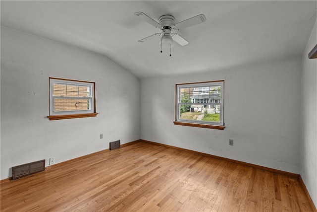 unfurnished room featuring light hardwood / wood-style floors, ceiling fan, and vaulted ceiling