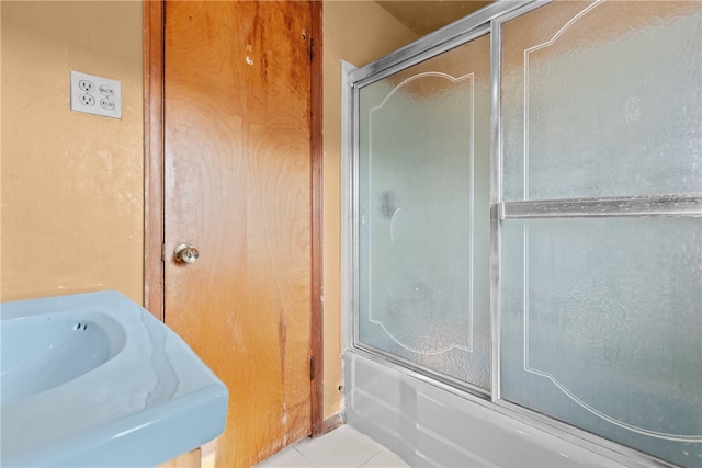 bathroom with tile patterned floors and combined bath / shower with glass door