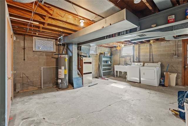 basement with sink, separate washer and dryer, and water heater