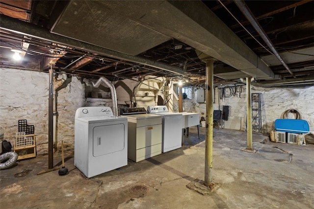 basement with washing machine and dryer and electric panel